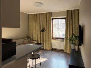 a living room with a couch and a table at Apartamenty Delecta in Krakow