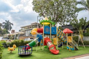 a playground with a slide in a park at Afro Park Hotel in Kampala