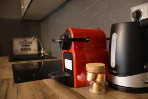 a coffee maker sitting on a counter next to a toaster at Le Jacuzzi Room in Perpignan