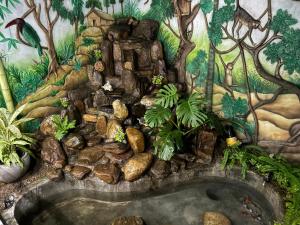 a painting of a garden with a bath tub at Jasmine Breeze Villa in Kadawata