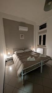 a bedroom with a large bed with two lights on it at White House B&B in Melfi +26 photos