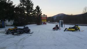 a group of three motorcycles parked in the snow at Coach Stop Inn in Gaines