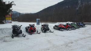 a group of motorcycles parked in the snow at Coach Stop Inn in Gaines