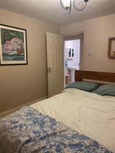 a bedroom with a bed and a picture on the wall at Pine Tree Cottage in Linslade