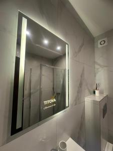 a bathroom with a mirror and a sink at Emerald Mamba - Titova Vila in Zlatibor +27 photos