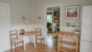 a kitchen with a table and chairs in a room at Svingen Apartments in Balestrand