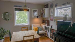 a living room with a table and a couch at Svingen Apartments in Balestrand