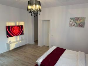a bedroom with a bed and a painting on the wall at VISAJ Jacuzzi Romantic in Timişoara +8 photos