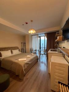 a bedroom with a bed and a kitchen with a table at Nirvana Stays Gudauri in Gudauri