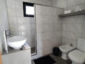 a bathroom with a sink and a toilet at Cabañas El Nono in Tandil +29 photos