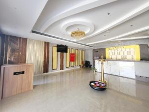 a lobby with a television and a bowl on the floor at Celestial International in Taliparamba