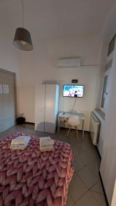 a bedroom with a bed and a tv and a table at White House B&B in Melfi