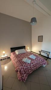a bedroom with a large bed with a large blanket at White House B&B in Melfi