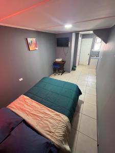 a bedroom with a bed in the corner of a room at Hostal JV Loft Simple in Nogales
