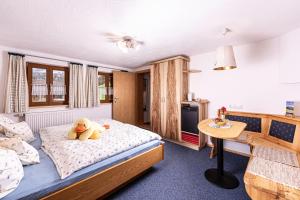 a bedroom with a teddy bear sitting on a bed at Mayringerlehen in Ramsau +35 photos