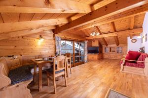 a large room with wooden ceilings and a table and chairs at Mayringerlehen in Ramsau