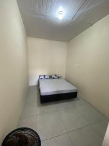 a room with a bed in the corner of a room at Casa São Francisco do Sul - #2 in São Francisco do Sul