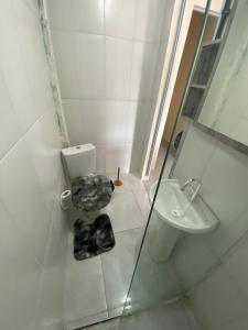 a bathroom with a toilet and a sink at Casa São Francisco do Sul - #2 in São Francisco do Sul