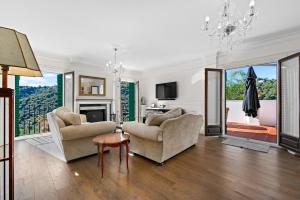 a living room with two chairs and a fireplace at Villa Atajate Secret by SuperHosts in Atajate