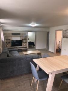 a living room with a couch and a table at Villa Oasis 3 in Kalithies
