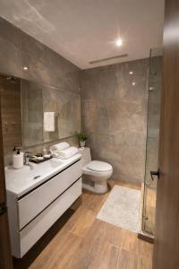 a bathroom with a toilet and a sink and a shower at Durán Business Suites near Airport in Bogotá +49 photos