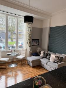 a living room with a couch and a table at Prime location Clifton 2 bed self contained spacious garden apartment in Bristol