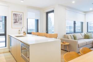 a kitchen and living room with a couch at Summit Central in Revelstoke