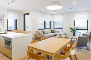 a kitchen and living room with a table and a couch at Summit Central in Revelstoke