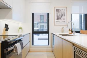 a kitchen with white counters and a sink at Summit Central in Revelstoke
