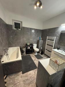 a bathroom with a tub and a sink and a toilet at Apartment PMH in Veľká Mača +21 photos