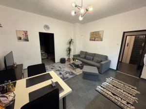 a living room with a couch and a table at Apartment PMH in Veľká Mača