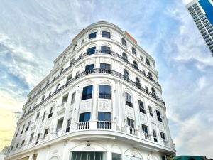 a white building with a balcony on the side of it at Entire Studio Apartment with King Bed in Ajman  +7 photos