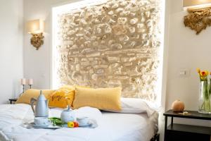 a bedroom with a stone wall and a bed at Casa Rachele alloggio turistico in Sabina in Poggio Mirteto