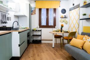a kitchen and living room with a table and a couch at Casa Rachele alloggio turistico in Sabina in Poggio Mirteto