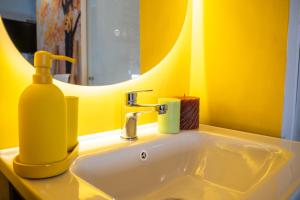 a yellow bathroom sink with a soap dispenser on it at Casa Rachele alloggio turistico in Sabina in Poggio Mirteto