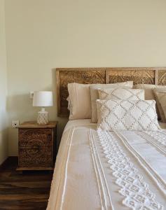 a bedroom with a large bed with a wooden headboard at El Mirador del Susarón in Puebla de Lillo