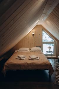 a bedroom with a bed with two towels on it at Veranda Rozhanka in Verkhnyaya Rozhanka
