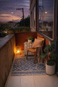 a balcony with a bench and a light on it at Copacabana Stay in Serra