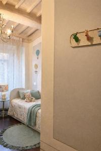 a bedroom with a bed and a room with a window at Ginevra Suite in Cortona