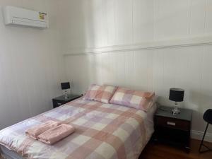 a bedroom with a bed with two towels on it at Gabba Beautiful rooms in Brisbane