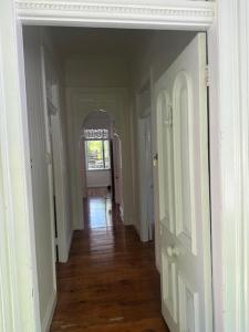 an empty hallway with a hallway leading to a room at Gabba Beautiful rooms in Brisbane