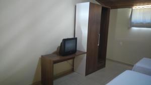 a small television sitting on a table in a room at Rancharia Park Hotel in Rancharia