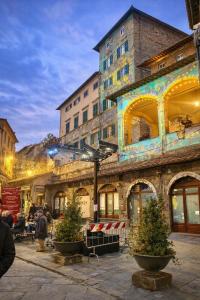 a group of people sitting outside of a building at Ginevra Suite in Cortona