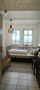 a bedroom with a large bed and two windows at Pension Burgenring in Schlitz