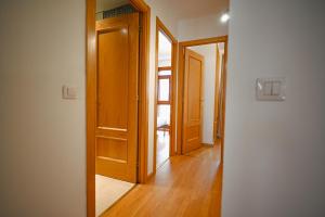 a hallway with an open wooden door and a room at A un paso de Grandvalira I Refugio Amplio y Sereno I Solanelles in Soldeu +22 photos