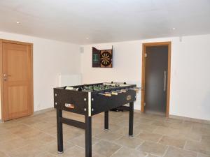 a foosball table in a room with a door at stunning Family Gîte Retreat in Stoumont