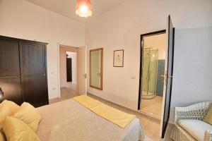 a bedroom with a bed and a large mirror at Lemon Home in Olbia