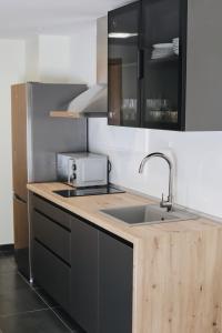 a kitchen with a sink and a counter top at El Mirador del Susarón in Puebla de Lillo