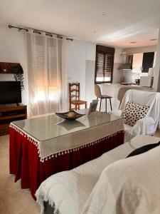 a living room with a table and a kitchen at Apartamento La alberca 1 in Aracena +49 photos
