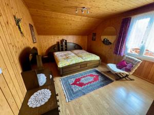 a bedroom with a bed and a chair in a room at Staldenried Ferienwohnung in Staldenried